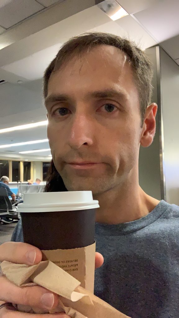 Close up shot of person drinking coffee with a sad frown